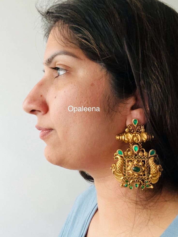 Exquisite gold jhumka earrings adorned with vibrant green stones - a stunning addition to your jewellery collection.  Length: 7.7 cms  Width: 5.6 cms  Weight: 51 cms Green Chandbali Bridal Earrings With Latkans, Green Chandbali Danglers Temple Jewelry, Green Chandbali Danglers In Temple Jewelry Style, Green Temple Jewelry Bridal Earrings For Festive Occasion, Festive Green Temple Jewelry Bridal Earrings, Green Kundan Drop Dangler Earrings, Green Kundan Drop Earrings, Green Kundan Drop Danglers, Green Latkans Earrings For Diwali