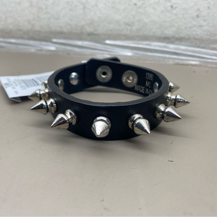 New Unisex Hot Topic Black Chrome Spiked Rocker Biker 3/4” Wide Bracelet Size M/L Black Rocker Bracelet With Studs, Rocker Style Spike Bracelets For Festivals, Black Rocker Style Leather Bracelet With Studs, Adjustable Punk Leather Bracelet, Black Punk Wristband For Concert, Rock Style Spiked Jewelry For Concerts, Black Spiked Jewelry For Concerts, Trendy Adjustable Spiked Bracelets, Adjustable Black Leather Grunge Bracelet