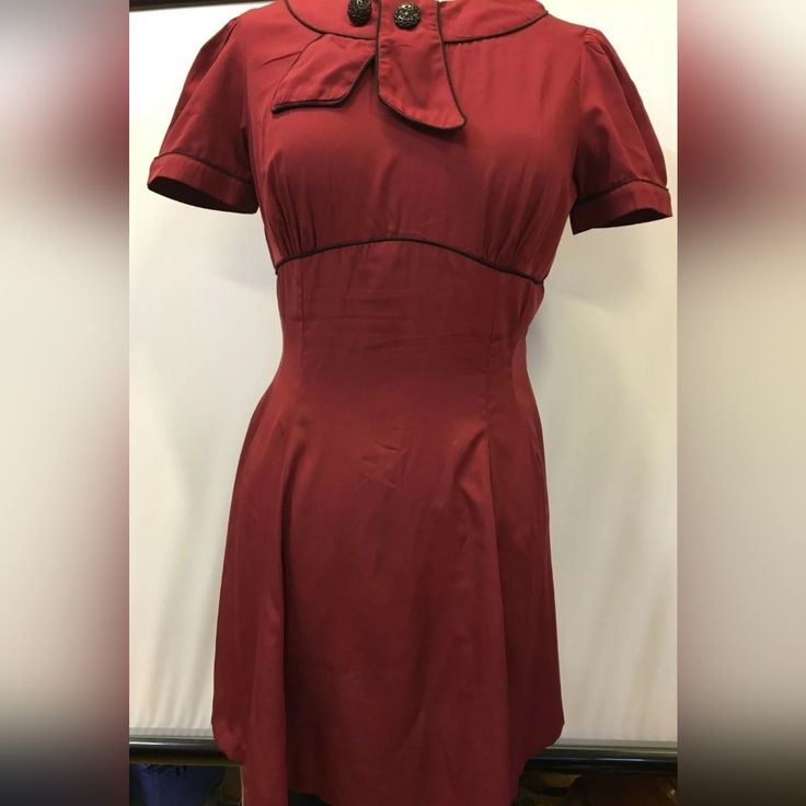 Step Back Into The Glamorous World Of The 1950s With This Stunning Hell Bunny Vixen Retro Style Party Dress In Burgundy! Perfect For Any Occasion, From Parties To Cosplay Events, This Dress Is Designed To Fit And Flatter Any Figure With Its Fit And Flare Style. The Dress Is Made From High-Quality Materials And Is In Very Great Condition, Never Used. The Dress Features A Sailor-Style Collar, Adding A Touch Of Vintage Charm To The Overall Look. The Beautiful Burgundy Colour Is Perfect For Any Seas Retro A-line Vintage Dress For Formal Occasions, Vintage Red Dress For Costume Party, Fitted Vintage Dress With Short Sleeves For Costume Party, Red 1950s Style A-line Vintage Dress, Short Sleeve Rockabilly Dresses For Vintage Fashion, Rockabilly Short Sleeve Vintage Dress, Fitted Short Sleeve Rockabilly Vintage Dress, Retro Solid A-line Vintage Dress, Fitted Vintage Dress In Solid Color