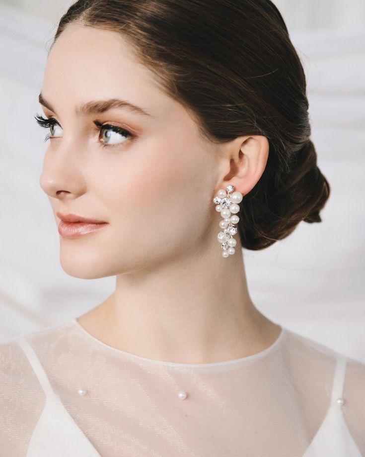 "BIANCA PEARL EARRINGS (JE-4463) Complete your bridal look with our Bianca Pearl Earrings. With a hand wired, dangle design, sparkling round crystals, and lustrous round pearls, these earrings embody elegance and sophistication. Perfect for the stylish bride seeking a touch of luxury on her special day.  DETAILS * White pearls and crystal beads * 2\" length * Hypoallergenic, lead-free & nickel-free * Style #4463 SHOP MORE STYLES https://www.etsy.com/shop/darethcolburndesigns NEED MORE HELP? Happy to offer advice or recommendations, just message me!" Wedding Earrings Pearl, Bridal Drop Earrings, Crystal Wedding Earrings, Pearl Earrings Designs, Drop Earrings Wedding, Pearl Bridal Earrings, Crystal Comb, Pearl Statement Earrings, Sparkle Design