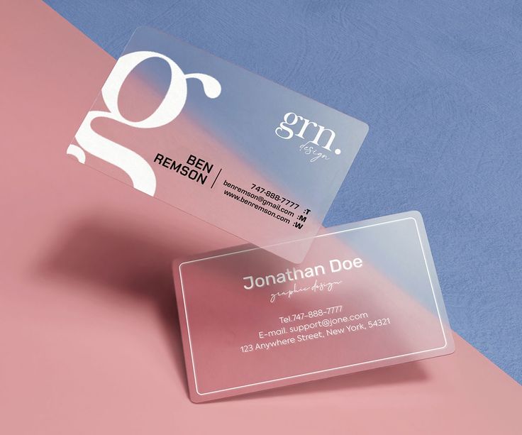 two business cards sitting on top of each other in front of a pink and blue background