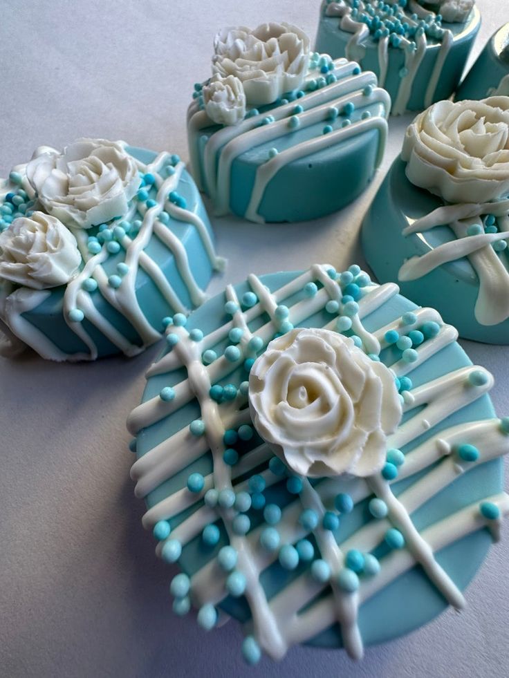 blue and white decorated cookies with flowers on them