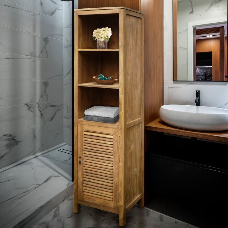 a wooden cabinet sitting next to a bathroom sink