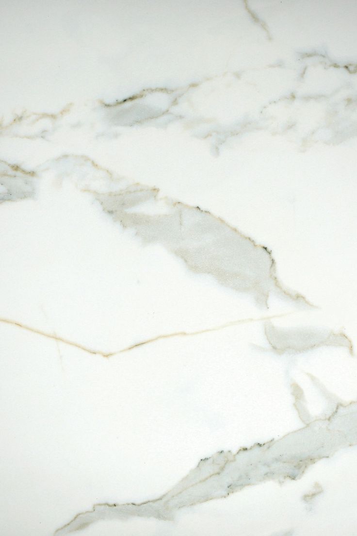 a white marble counter top with cracks in it