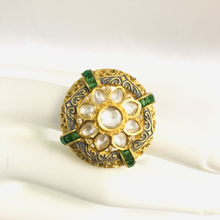 Gray Meenakari Emerald Kundan Adjustable Ring/ Amrapali Rajwadi Ring/ Sabyasachi Ring/ Statement Ring/ Indian Wedding Kundan Ring Description: Made in Brass with Kundan, Cubic Zirconia Stones and Emerald Green Semi-precious stones Handmade Kundan Jadau Statement Ring Width: Approx. 1.25 Inches Adjustable Ring Lightweight Ring Suitable for any traditional or contemporary occasion Jaipuri/Rajwadi Jewelry Check our complete Kundan and Cubic Zirconia Rings collection here: https://www.etsy.com/shop/ Luxury Elegant Meenakari Rings, Gold Kundan Rings In Temple Jewelry Style, Gold Meenakari Rings For Festive Occasions, Gold Rings With Meenakari For Festive Occasions, Festive Gold Ring With Meenakari Detail, Festive Gold Ring With Meenakari, Traditional Wedding Rings With Stone Work, Festive Kundan Hand Set Rings, Festive Kundan Rings With Hand Set