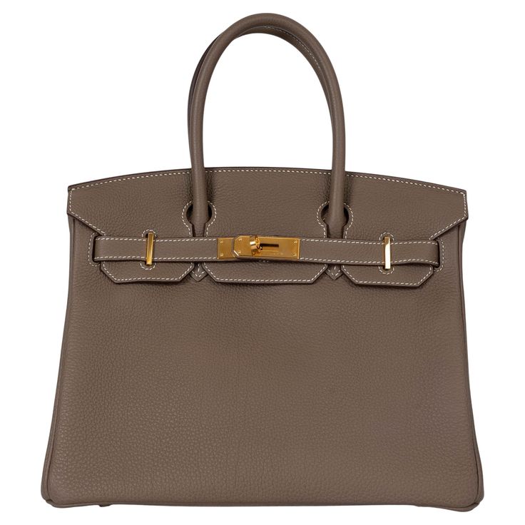 100% authentic Hermès Birkin 30 bag in Etoupe (taupe) Veau Togo leather with gold-plated hardware and contrasting white stitching. Lined in Chèvre (goat skin) with an open pocket against the front and a zipper pocket against the back. Has been carried and is in virtually new condition. Comes with Full Set. Measurements Model H027633CC 18 Height 22cm (8.6in) Width 30cm (11.7in) Depth 15cm (5.9in) Drop of the Handle 10.5cm (4.1in) Hardware Gold-Plated Blindstamp Z (2021) All our listings include o Birkin 30 Etoupe, Hermes Etoupe, French Tote Bag, Birkin Bags, Embroidered Shoulder Bag, Birkin 30, Modernist Jewelry, Hermes Birkin 30, Togo Leather