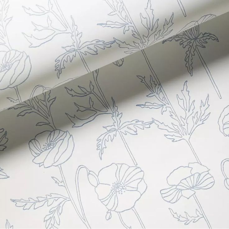 a white wallpaper with blue flowers on it