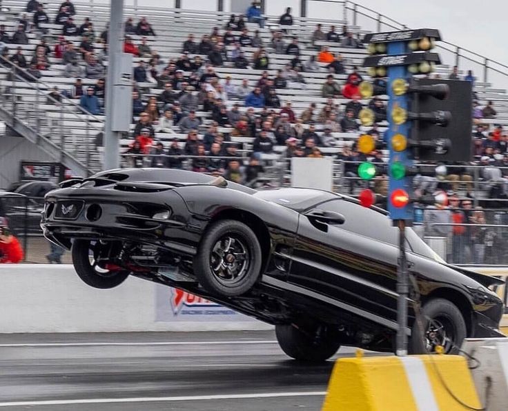 a black car that is flying through the air