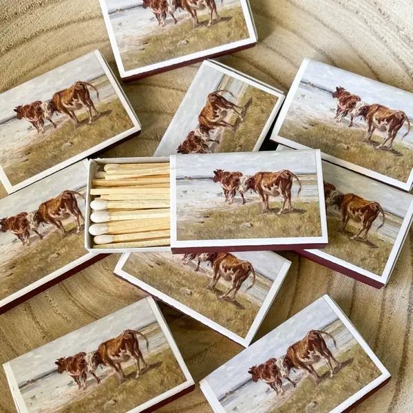 several matches with pictures of cows on them