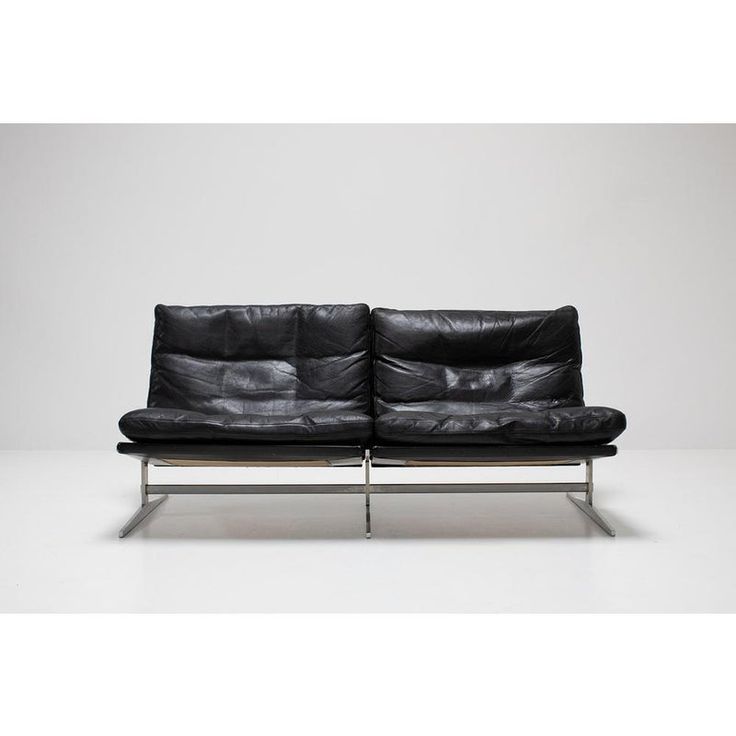 a black leather couch with chrome legs