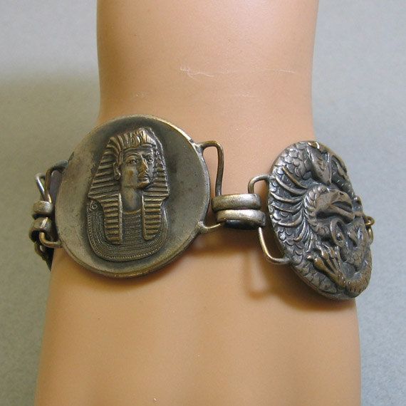 Egyptian Themed Aged Brass Link Bracelet, 1960s, Big, Bold Silver Vintage Bracelets With Antique Finish, Antique Brass Collectible Bracelets, Vintage Bronze Coin-shaped Jewelry, Adjustable Antique Metal Bracelet, Antique Nickel-free Bracelets, Adjustable Antique Metal Bracelets, Vintage Nickel-free Bronze Bracelets, Adjustable Antique Nickel-free Bracelet, Symbolic Metal Bracelets