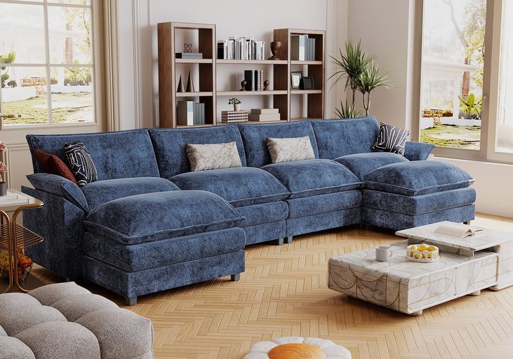 a living room with blue couches and large windows