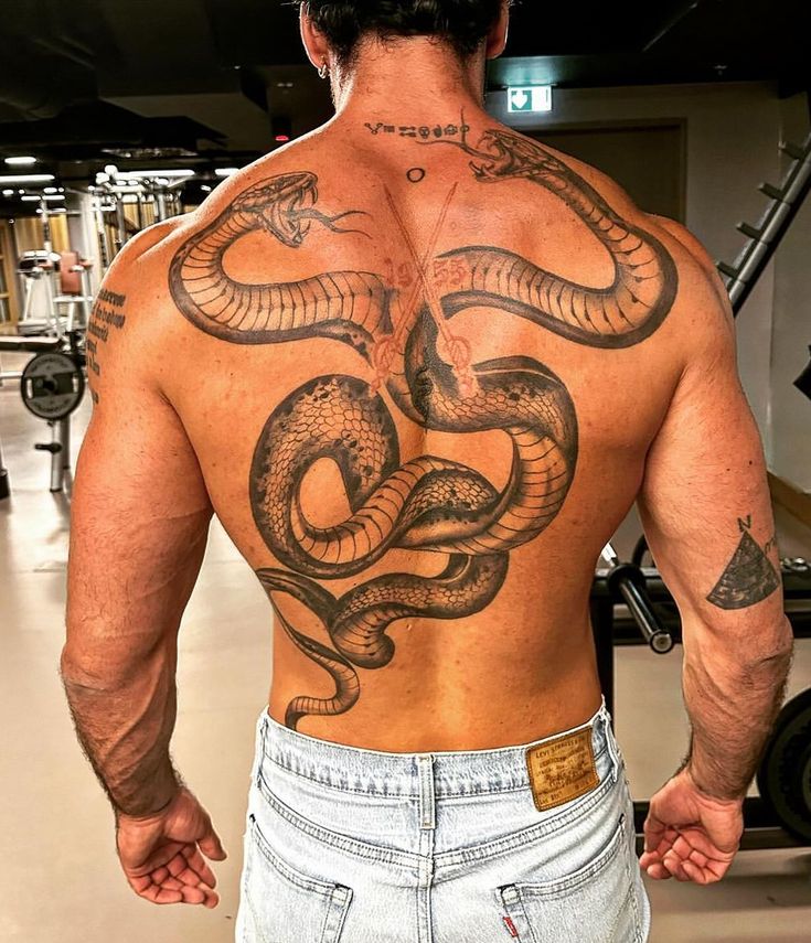 a man with a snake tattoo on his back