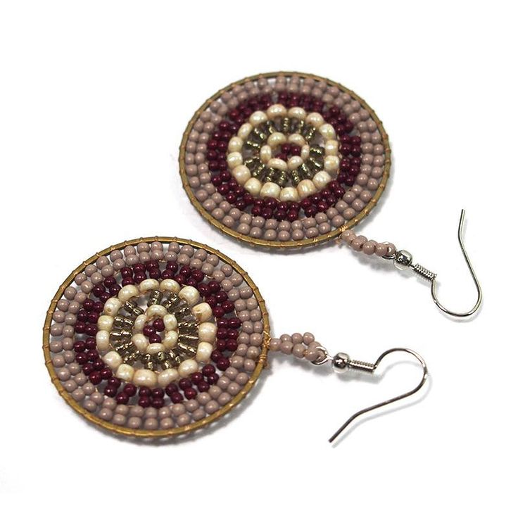 two pairs of beaded earrings with dangling hooks on white background, one is red and the other is brown