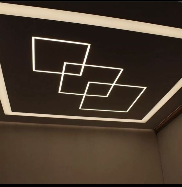 the ceiling is lit up with square and rectangle shapes in white on a black background