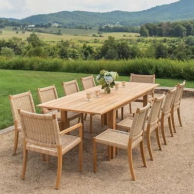 a wooden table and chairs sitting on top of a dirt field