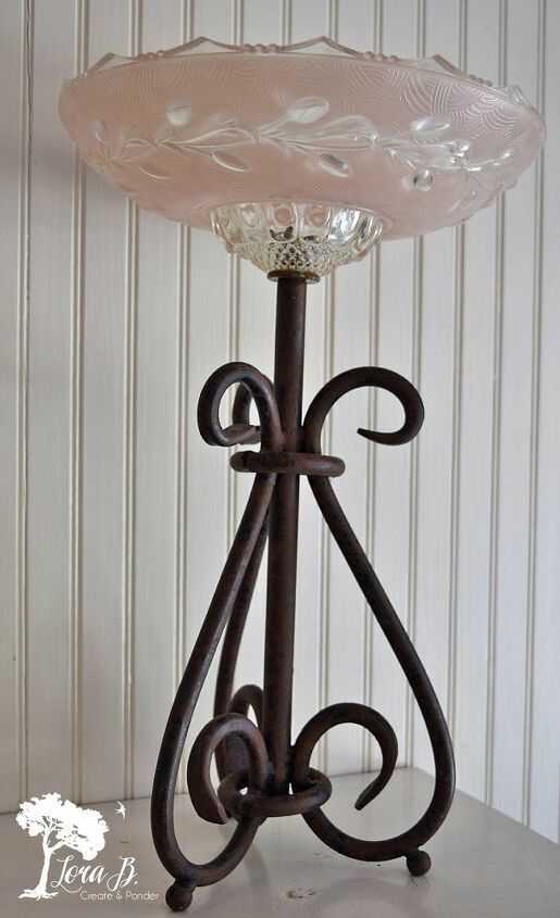 a glass lamp sitting on top of a table