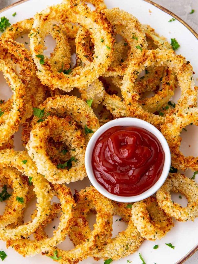 fried onion rings with ketchup on a plate