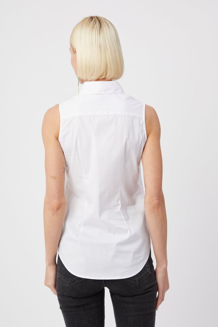 Our warm weather cotton staple. The Sleeveless Shirt is a classic for layering or to wear on its own. Narrow armholes mean bra won't peek through the side (and won't peek through the front either). Rochelle Behrens reimagined how shirts should fit and feel. Our patented No Gape® button technology, seamlessly designed into every shirt and shirtdress we design, eliminates blouse gape. Finally say bye bye blouse gape, hello The Shirt. 75% Cotton, 20% Nylon, 5% Stretch Made In Portugal Powered by ou Cotton Tops With Built-in Bra For Daywear, Cotton Sleeveless Vest With Built-in Bra, Cotton Vest Blouse For Work, Summer Cotton Vest With Built-in Bra, Classic Sleeveless Tops For Everyday, Classic Cotton Vest Top, Stretch Cotton Tank Top For Daywear, Stretch Cotton Tops For Daywear, Classic Cotton Sleeveless Tank Top