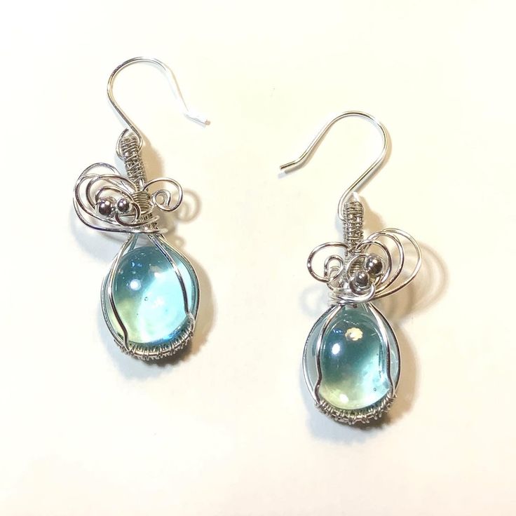 "Tiny Aqua glass Cabochons wire wrapped with silver non tarnish wire... made into these cute fancy earrings.  These are 2\" drop length.  Cabochon is about 15mm or 1.5cm.   Ear hooks also non tarnish silver plate wire 20 gauge. You can also choose an antique copper with green cabochon variation." Nickel-free Teardrop Czech Glass Earrings, Unique Wire Drop Earrings, Nickel-free Teardrop Glass Earrings, Sterling Silver Wire-wrapped Crystal Drop Earrings, Nickel-free Czech Glass Teardrop Earrings As Gift, Wire Wrapped Teardrop Glass Earrings, Glass Teardrop Earrings With Ear Wire, Wire Wrapped Glass Teardrop Earrings, Teardrop Wire Wrapped Glass Earrings