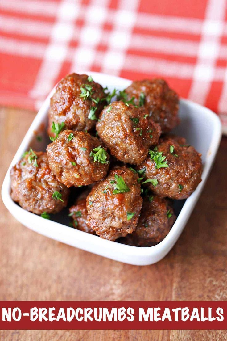 baked meatballs in a white bowl with parsley on top and text overlay reading baked meatballs low carb, gluten free