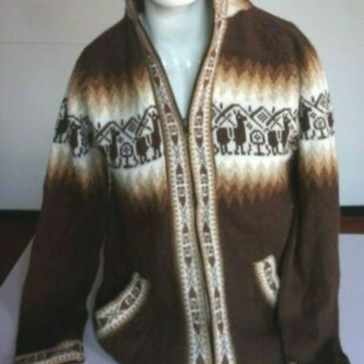 a mannequin wearing a brown and white sweater with an elephant design on it