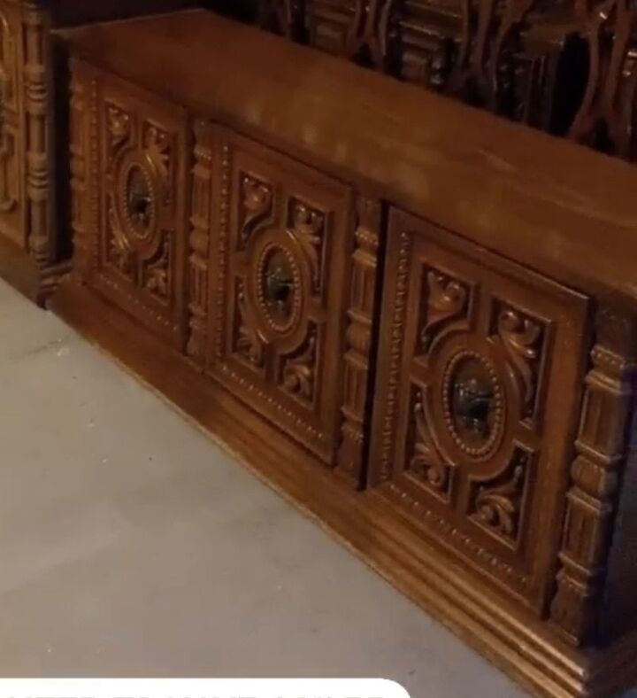 an old wooden bed with intricate carvings on it