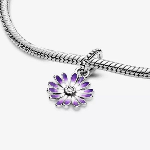 Absolutely gorgeous, high quality 925 sterling silver, daisy dangle charm with enamel that graduates in color from the center to the edge of each petal. A sparkling cubic zirconia crystal lays in the center. Makes a lovely addition to your charm bracelet or as a gift for someone special. You can also place this charm on a chain for a simple, yet stunning necklace. This charm will fit all top brand charm bracelets including brands such as Pandora and Chamilia. It will also fit 3mm European snake Sterling Silver Flower Charm, Sterling Silver Jewelry With Purple Flower Charm, Purple Sterling Silver Jewelry With Flower Charm, Purple Jewelry With Flower Charm For Mother's Day, Purple Daisy, Turtle Charm, Pandora Bracelet Charms, Pandora Charm, Dangle Charms