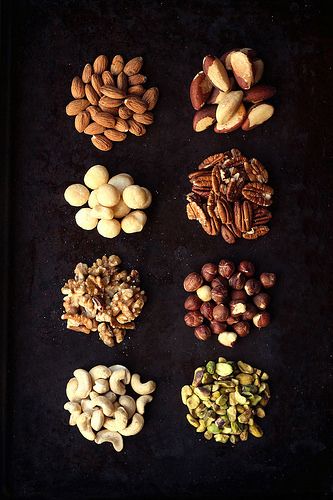 nuts and seeds are arranged on a baking sheet