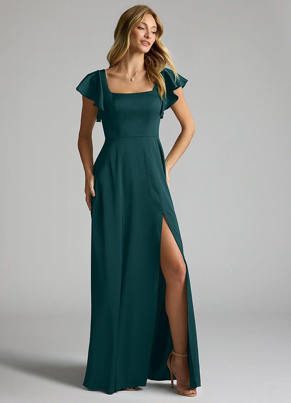 a woman in a long green dress with a slit down the side and one leg