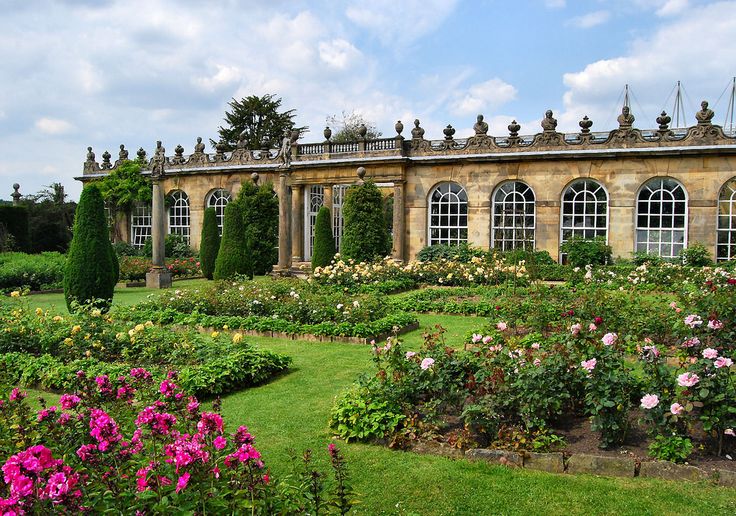 a large building with many windows and lots of flowers