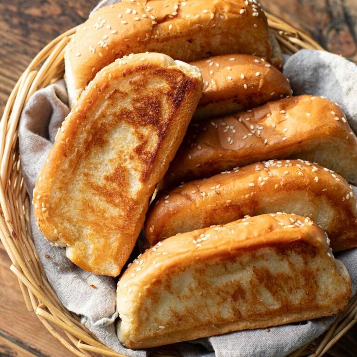 a basket filled with fried bread on top of a wooden table