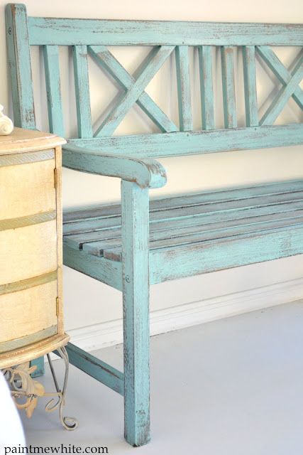 a blue bench sitting next to a dresser