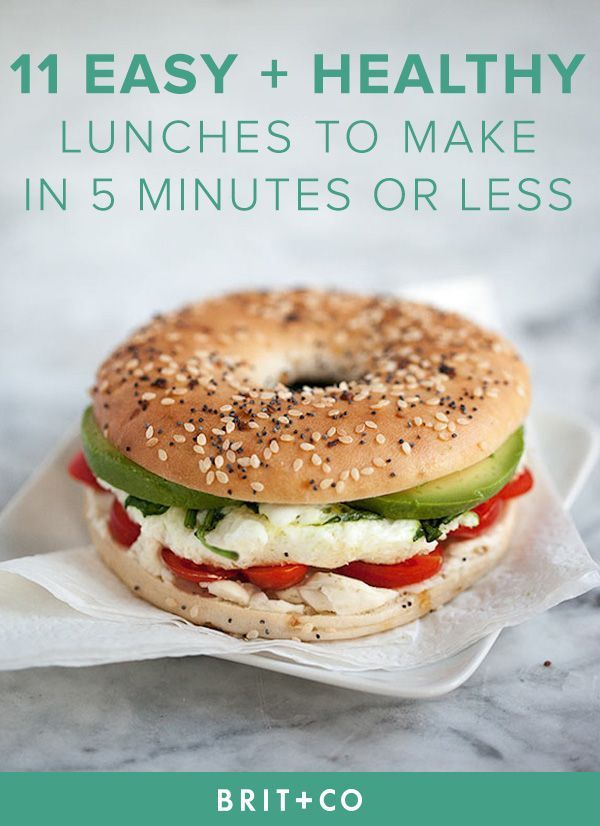 a bagel sandwich with cheese, lettuce and tomato on it sitting on a napkin