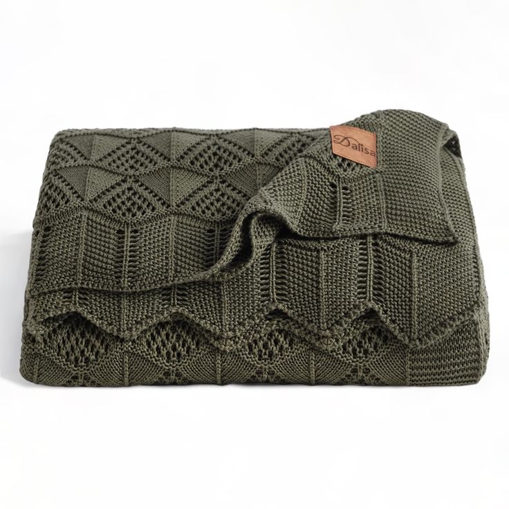 an olive green knitted clutch bag on a white background