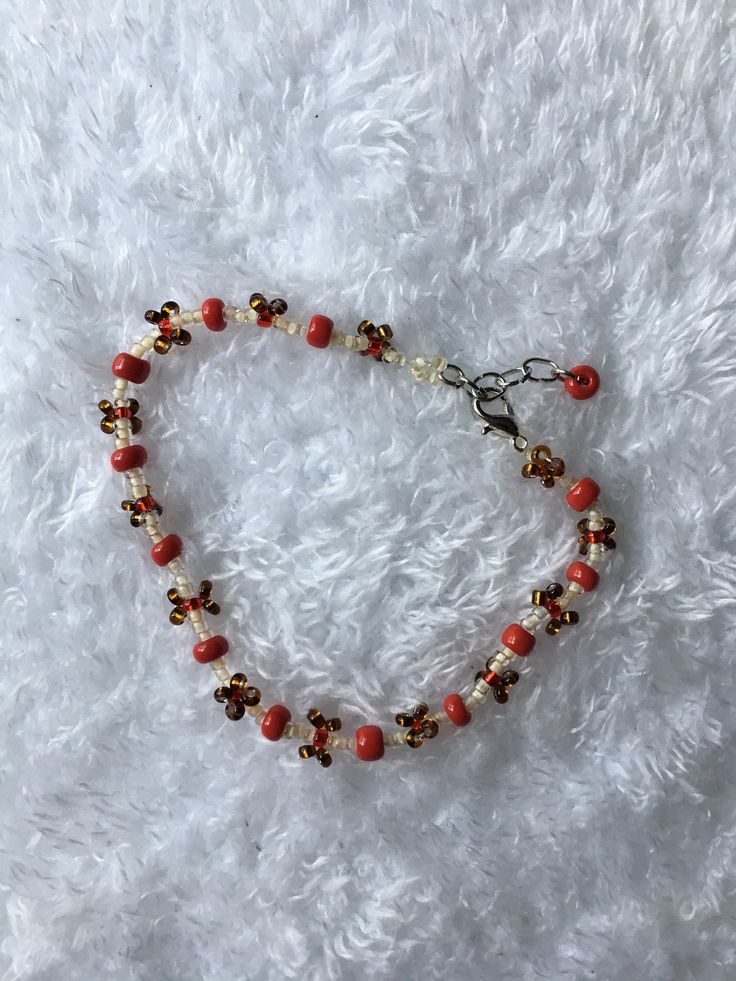 This red toadstool inspired beaded bracelet is made with glass beads, silver chain, and jewelry thread. While the base color may be a simple cream, bright notes of red and earthy brown help to make this bracelet more striking. The listed size is the smallest the bracelet will fit. All bracelets are adjustable with an added chain that  increases the size by about an inch. As seed beads are at times irregular, and I have to account for the pattern, there might be very slight size discrepancies bet Brown Bracelets With Tiny Beads For Gift, Brown Bracelets With Tiny Beads As Gift, Red Bohemian Crystal Bracelet With Round Beads, Brown Tiny Beads Bracelet, Bohemian Red Crystal Bracelet With Round Beads, Handmade Brown Beaded Bracelets With Czech Glass, Handmade Czech Glass Brown Beaded Bracelets, Handmade Brown Czech Glass Beaded Bracelets, Red Czech Glass Bracelets With Colorful Beads