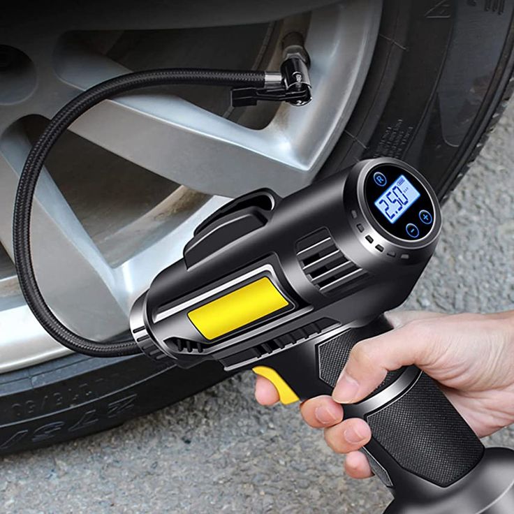 a person is holding an electric drill in front of a car's brake pump