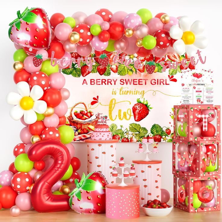 a strawberry sweet girl birthday party with balloons and decorations