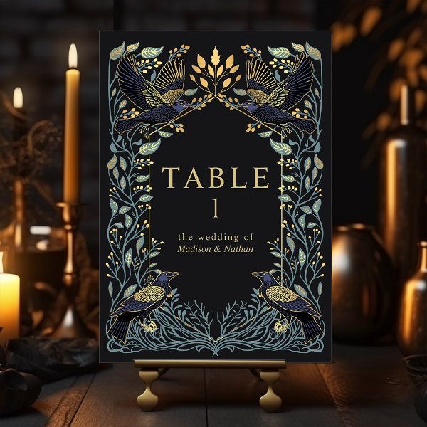 a table sign sitting on top of a wooden table next to candles and vases