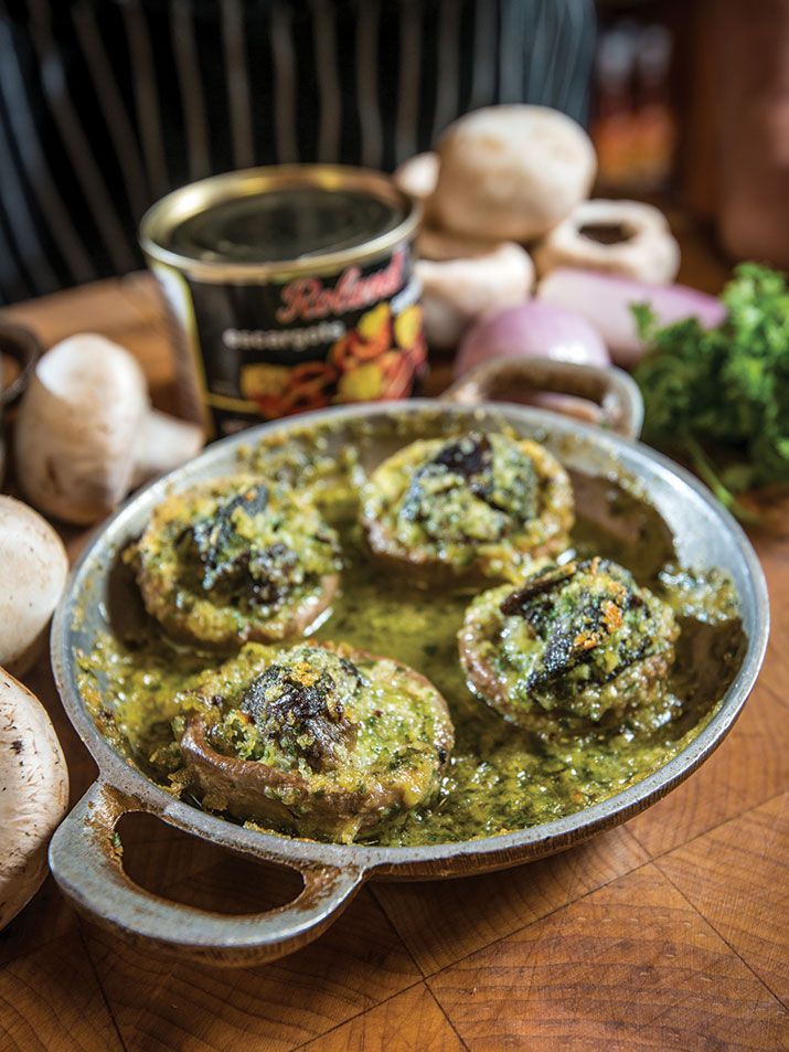 mushrooms and pesto sauce in a pan on a table