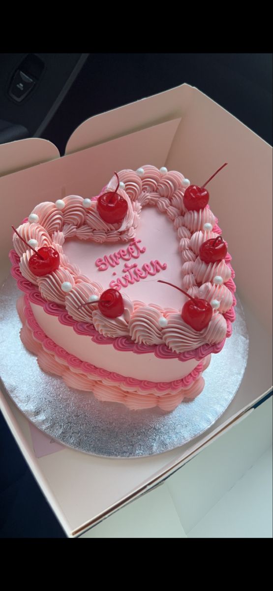 a heart shaped cake in a pink box