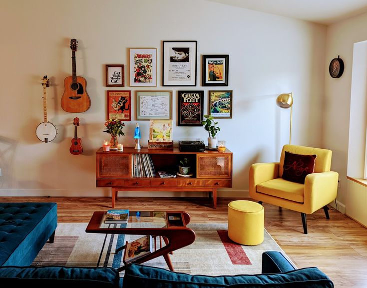 a living room filled with furniture and pictures on the wall