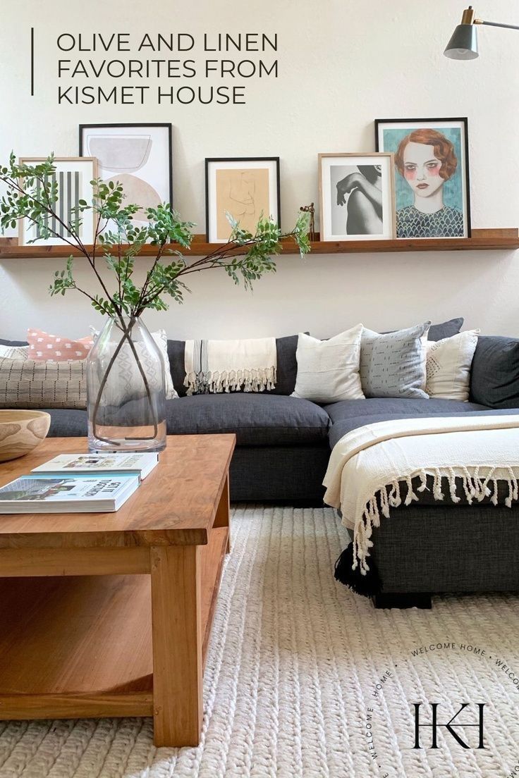 a living room with pictures on the wall and a couch in front of a coffee table