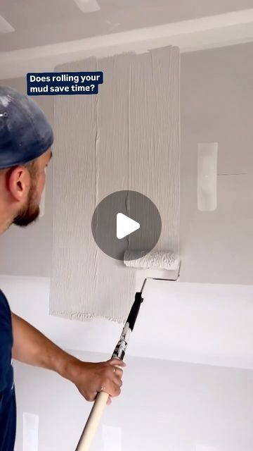 a man holding a paint roller in front of a wall with the words does painting your walls look like this?