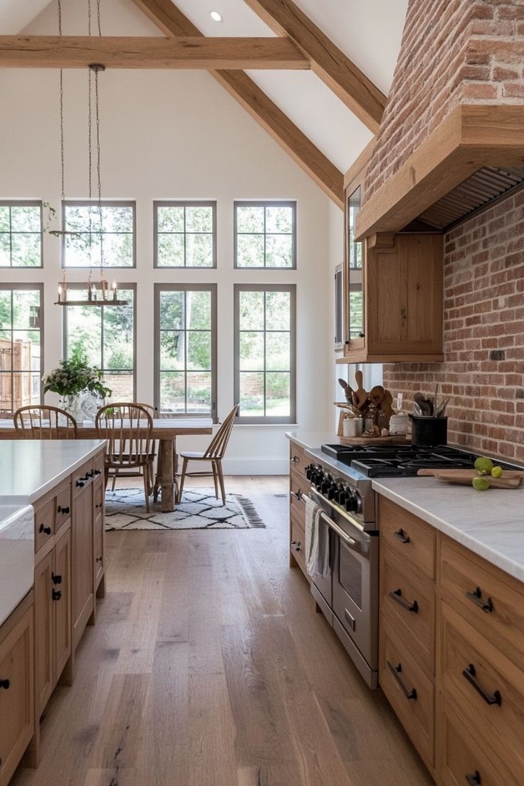 a kitchen with wooden cabinets and an island in front of a brick wall that matches the ceiling