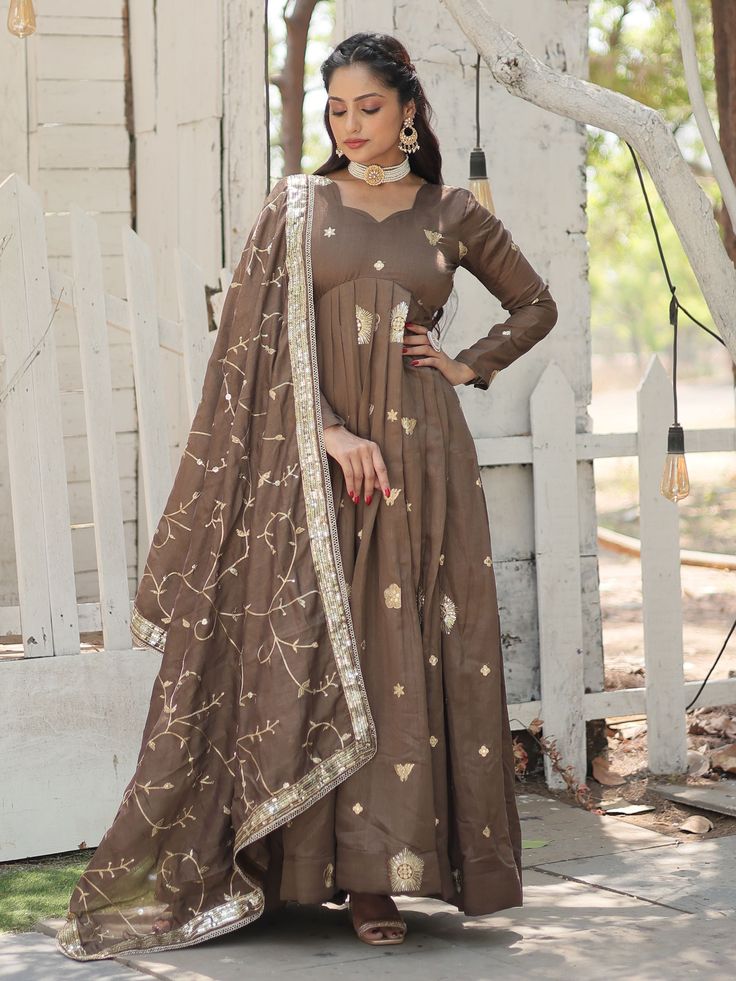 Introducing the stunning "attractive brown embroidered silk festival wear gown with dupatta" from Ethnic Plus. This gorgeous gown is perfect for any festival, event, or special function. Made from luxurious silk fabric, it features rich sequins and intricate embroidered work, giving it a truly elegant and sophisticated look.
This brown gown includes a beautifully rich color, a fully stitched design for convenience, and a matching silk dupatta with the same sequins and embroidery detail. The gown Punjabi Wedding Dress, Long Anarkali Gown, Wedding Dresses Pakistani, Lehenga Crop Top, Indian Wedding Lehenga, Gown With Dupatta, Lehenga Choli Wedding, Ethnic Gown, Reception Gown