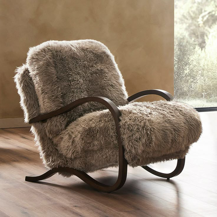 a rocking chair with sheepskin on it in front of a window and wood floor