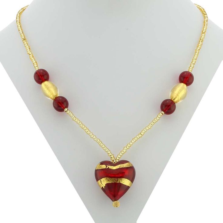 Every woman loves to own unique handcrafted jewelry. This Murano necklace in rich gold and red palette is every woman's dream, rich and beautiful like Venice itself. The authentic Murano necklace features an exquisite 24K gold-layered red heart pendant suspended from an elegant gold-lined beaded necklace accented with gorgeous 24K gold foil-lined Murano glass beads. Enjoy this unique Murano Necklace and the aura of Venetian romance and elegance that it projects. The heart measures 1 inch in heig Elegant Gold Beaded Necklace With Heart Beads, Elegant Gold Beaded Necklaces For Valentine's Day, Gold Necklaces With Heart Beads For Jewelry Making, Gold Heart Beads Pendant Necklace, Gold Pendant Necklace With Heart Beads, Elegant Red Heart Pendant Necklace, Red Beaded Necklace With Heart Pendant For Gifting, Gold Heart Beads Necklace For Gift, Gold Necklaces With Heart Beads For Gift