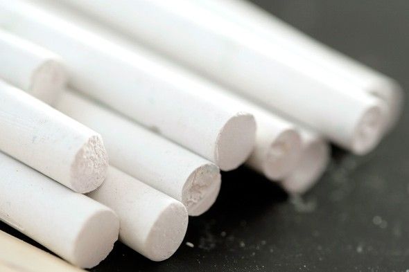 several white tubes are stacked on top of each other with the words chalk will remove grease stains from clothes simply rub the stain with chalk, then toss in the wash as normal