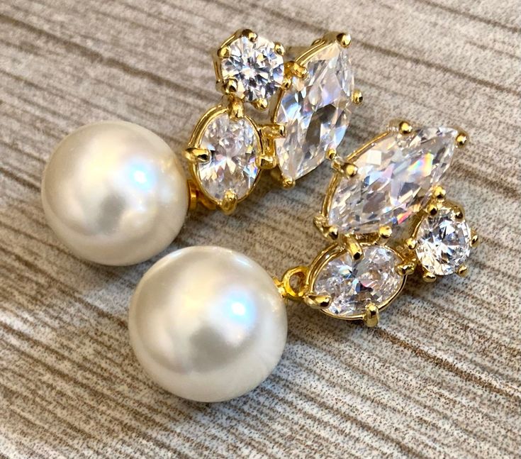 Pearl Rhinestone Earrings in Gold Cubic Zirconia rhinestone cluster earrings posts elegant chic classy Mothers Day Gift wedding earrings Come in a Gift Box! These earrings have large 12mm soft White crystal pearls and measure 1.25 inches long and are 1/2 inch wide. To see more jewelry visit my shop at http://www.AlexiBlackwellBridal.Etsy.com Elegant Clip-on Diamond Earrings For Anniversary, Gold Pearl Earrings With Diamond Accents And Cubic Zirconia, Classic Gold Cluster Earrings For Formal Occasions, Wedding Yellow Gold Clip-on Diamond Earrings, Elegant Anniversary Clip-on Diamond Earrings, Elegant Gold Clip-on Earrings With Diamond Accents, Elegant Gold Cluster Earrings For Formal Events, Elegant Yellow Gold Crystal Earrings For Anniversary, Elegant Yellow Gold Crystal Earrings For Evening